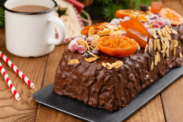Traditional christmas fruit cake pudding in chocolate glaze