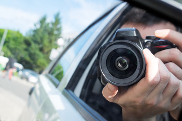 photographer with camera take photo from the car window