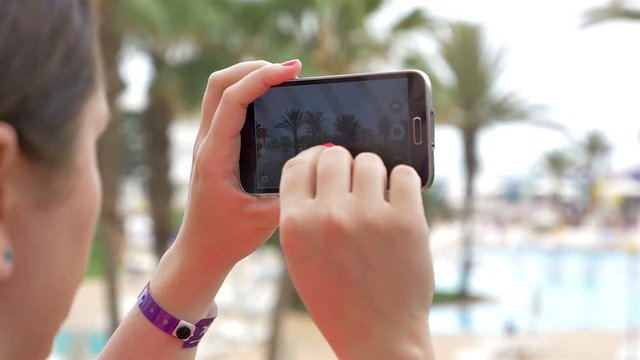 Two high quality videos of woman taking a picture on the vacation in 4k