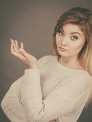 Confused young blonde woman looking annoyed