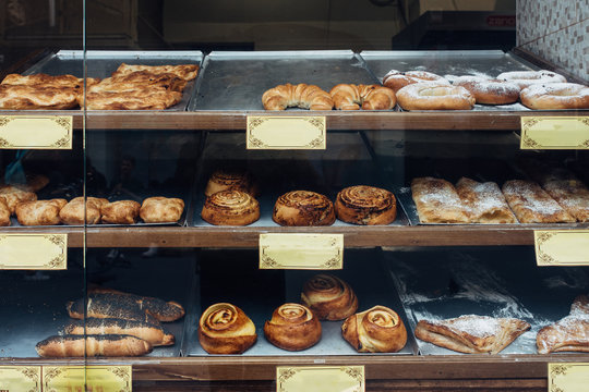 Various pastries in a bakery display window