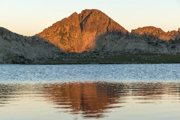 Sunset landscape with Kamenitsa peak and Tevno lake, Pirin Mountain, Bulgaria