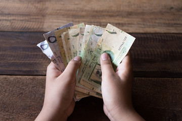 hand counting saudi riyal bank notes. financial concept