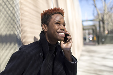 Young black man on a cellphone.