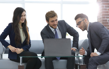 A business team of three planning work in office.