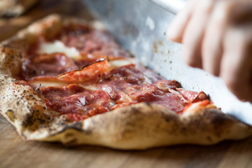 Salami being being sliced