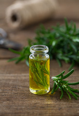 rosemary oil on wooden surface