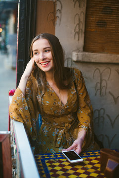 Young woman at cafe in the city
