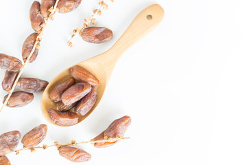 Dates fruit in wooden ladle on white background,Dried date palm fruits top view