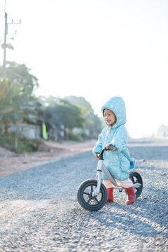 Asian boy about 1 year and 11 months with winter jacket is riding baby balance bike