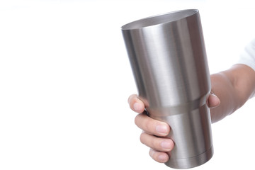 Hand holding stainless steel thermos mug for keeping  temperature like iced of hot water