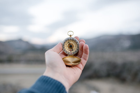 Crop male hand with compass
