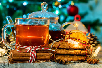 Cozy still life with tea, candle light and cookies