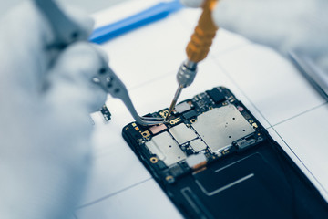 Man repairing smartphone.