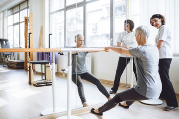 Senior Woman Doing Exercise on Barre