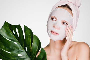 girl with a towel on her head put a mask on her face