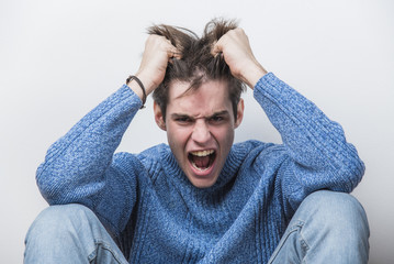 Young teenage man can't take it anymore, screaming with frustration