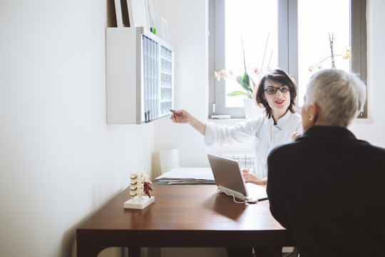 Physician Showing Spine Scan to her Patient