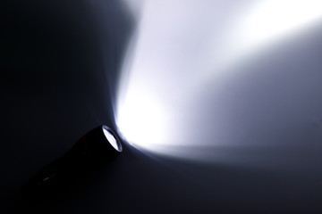 Beam of a flashlight on a white background, light and shadow concepts. - obrazy, fototapety, plakaty