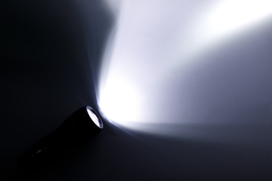 Beam Of A Flashlight On A White Background, Light And Shadow Concepts.