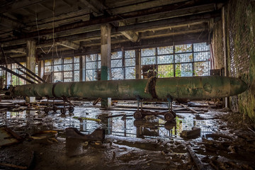 Fototapeta na wymiar Old rusted submarine torpedo in abandoned torpedo factory