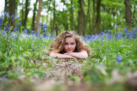 Girl laying on a woodland path