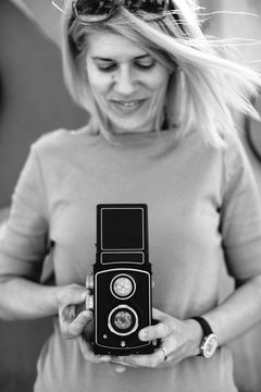 Smiling woman adjusting medium format camera