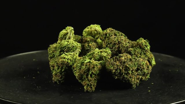 Marijuana Buds spinning indefinte loop against isolated black background