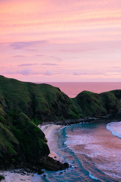 Purple, pink sunset sky over a secluded ideal beach