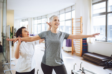 Woman Doing Fitness Exercise With Therapist
