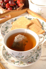 Tea bag in the cup with hot water 