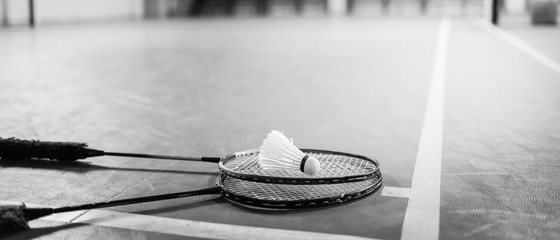 Badminton ball (shuttlecock) and racket on court floor - obrazy, fototapety, plakaty