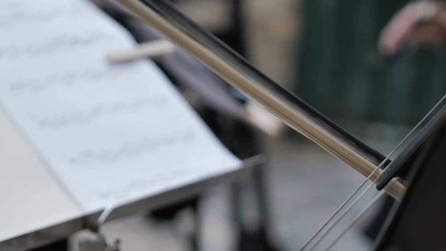 playing the Chello in slow motion outside