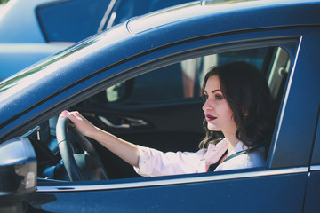 Pretty woman sitting in car