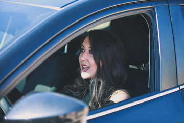 Beautiful woman driving blue car