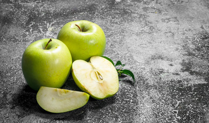 Green apples with leaves.