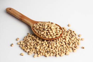 Bean paste is in a wooden spoon.