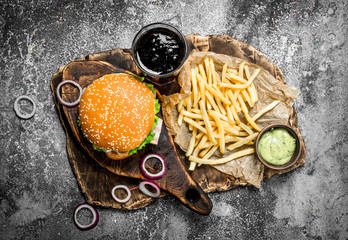 Street food. Burger with cola and fries.