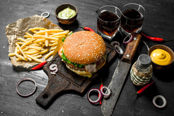 Street food. Fresh burger with cola, fries and sauces.
