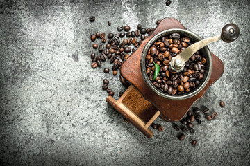 old hand-grinder with coffee beans.
