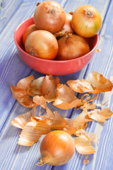 Fresh organic onions in bowl on boards, healthy nutrition concept