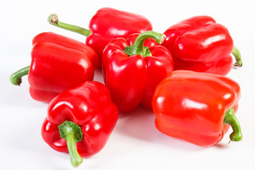Heap of red peppers on white background, concept of healthy nutrition