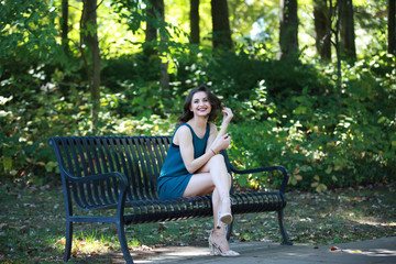 Cheerful pretty woman on bench