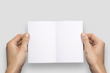 Empty white A6 postcard horizontally. Man holds a pattern in his hand on a gray background