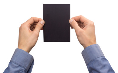 Obraz premium Mockup A6 empty blank black postcard vertically holds the man in his hand in shirt. Isolated on a white background