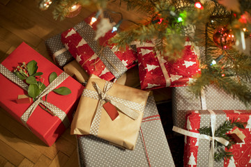 Fototapeta na wymiar Wrapped Christmas present under decorated Christmas tree