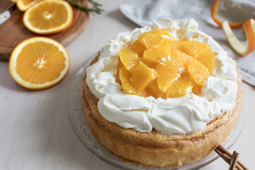 Riccota cake decorated with mascarpone cream and oranges