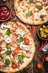 Two fresh pizzas with sauce.