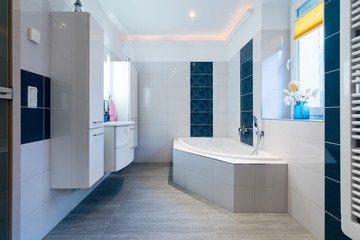 Fototapeta na wymiar Modern Bathroom - Glossy white and blue tiles - bathtub, sink and floor heating