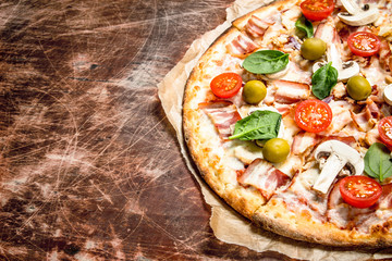 Fresh pizza with meat and tomatoes.